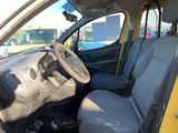 the interior of a small car with a steering wheel and dashboard