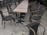 many chairs and a table in the middle of a gravel area