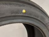 a close up of a tire with a yellow dot on it