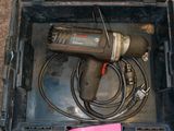 a tool in a case with a pink sticker on it