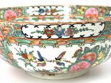 a colorful bowl with birds and flowers on it