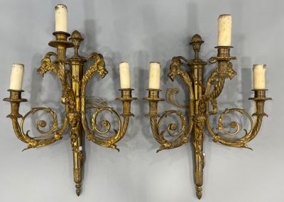 pair of antique brass wall sconces with white candles