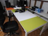 a desk with a laptop and a monitor on it