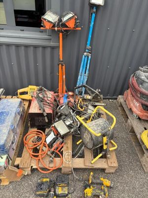 a pile of tools on a pallet in front of a building