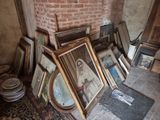 a lot of framed pictures on the floor in a room