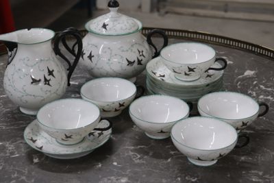 a lot of cups and saucers sitting on a table