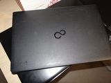 a black laptop sitting on top of a black chair