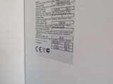 a white refrigerator with a black and white checkered label on it
