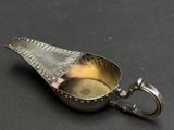 an image of a silver spoon with a handle on a black surface