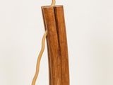 a small wooden vase with a stick sticking out of it