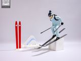 a figurine of a skier that is jumping over a jump