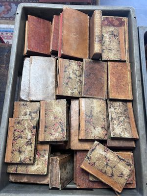 a box full of old books sitting on a table