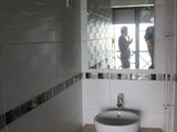 a bathroom with a sink and a mirror on the wall