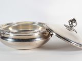 an image of a silver bowl with a lid sitting on a table