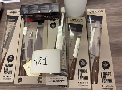 a lot of kitchen knives that are on the table