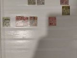 a man standing in front of a refrigerator with stamps on it