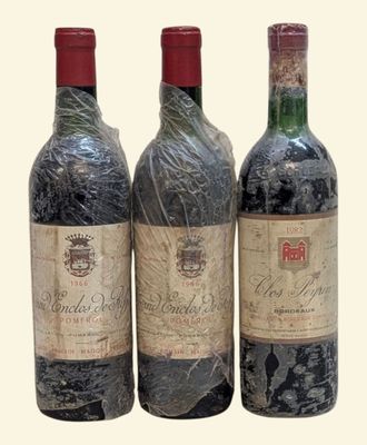 trois bouteilles de vin posées l'une à côté de l'autre sur une table