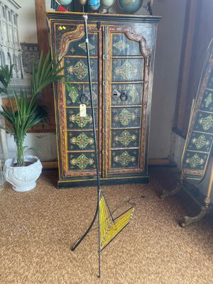 a tall wooden cabinet with a mirror and a lamp on it