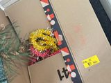 a person holding a box with a christmas tree inside of it