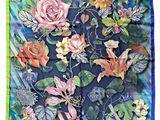a close up of a square scarf with flowers and leaves on it