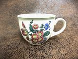a cup with a floral design on it on a table