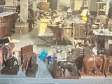 a lot of wooden statues on display in a store