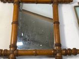 a mirror that is on a table with a picture on it