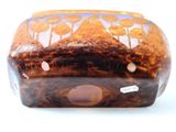 a brown vase with a design on it on a white surface