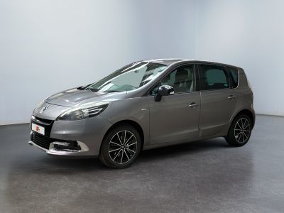 the silver car is parked in a white room with a black floor