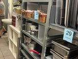 many pans and pans on the shelves in the kitchen
