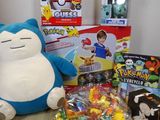 a stuffed animal sitting on a table next to a bunch of toys