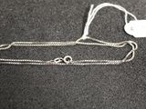 a close up of a silver chain with a tag on it
