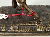 a bronze statue of a horse with a tag on it ' s neck