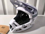 a helmet that is sitting on a table next to a book
