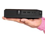 a person holding a small black computer in their hand