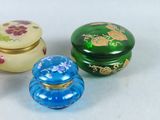 three small glass containers sitting next to each other on a table
