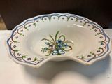a white bowl with blue and green flowers on it