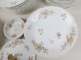 a lot of plates and bowls sitting on a table