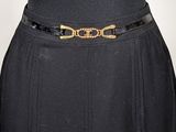 black dress with a gold buckle and a black skirt with a gold belt