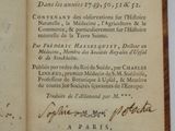 an old book with writing on it sitting on a table