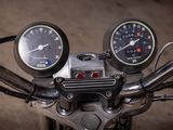 two gauges on the handlebars of a motorcycle