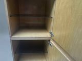 a wooden cabinet with two shelves and one door open