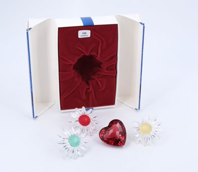 a box with a heart and two flowers inside of it