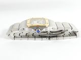 a silver and gold wrist watch on a white surface