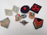 several different types of military badges are arranged on a white surface