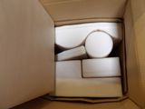 a cardboard box with a toilet and a toilet paper roll in it