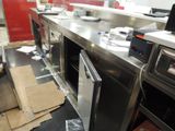 a picture of a kitchen with a lot of clutter on the floor