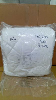 a pillow that is wrapped in plastic on a table