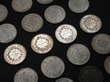 a lot of coins that are on a black surface
