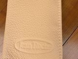 a close up of a wallet on a wooden table